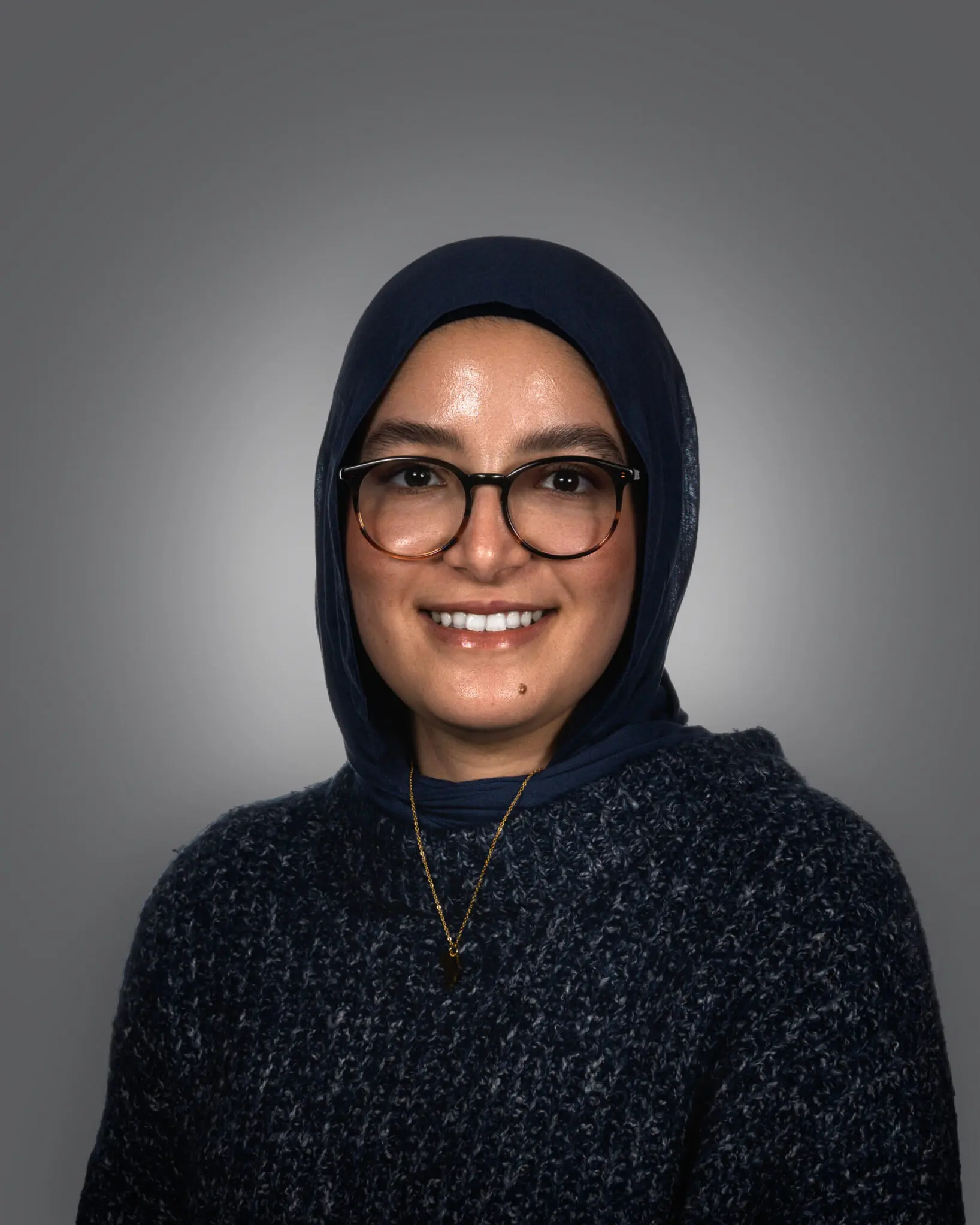 a person wearing glasses and a head scarf