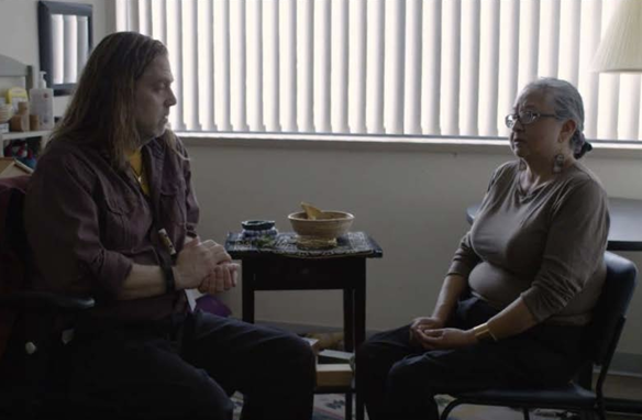 a person and person sitting in chairs