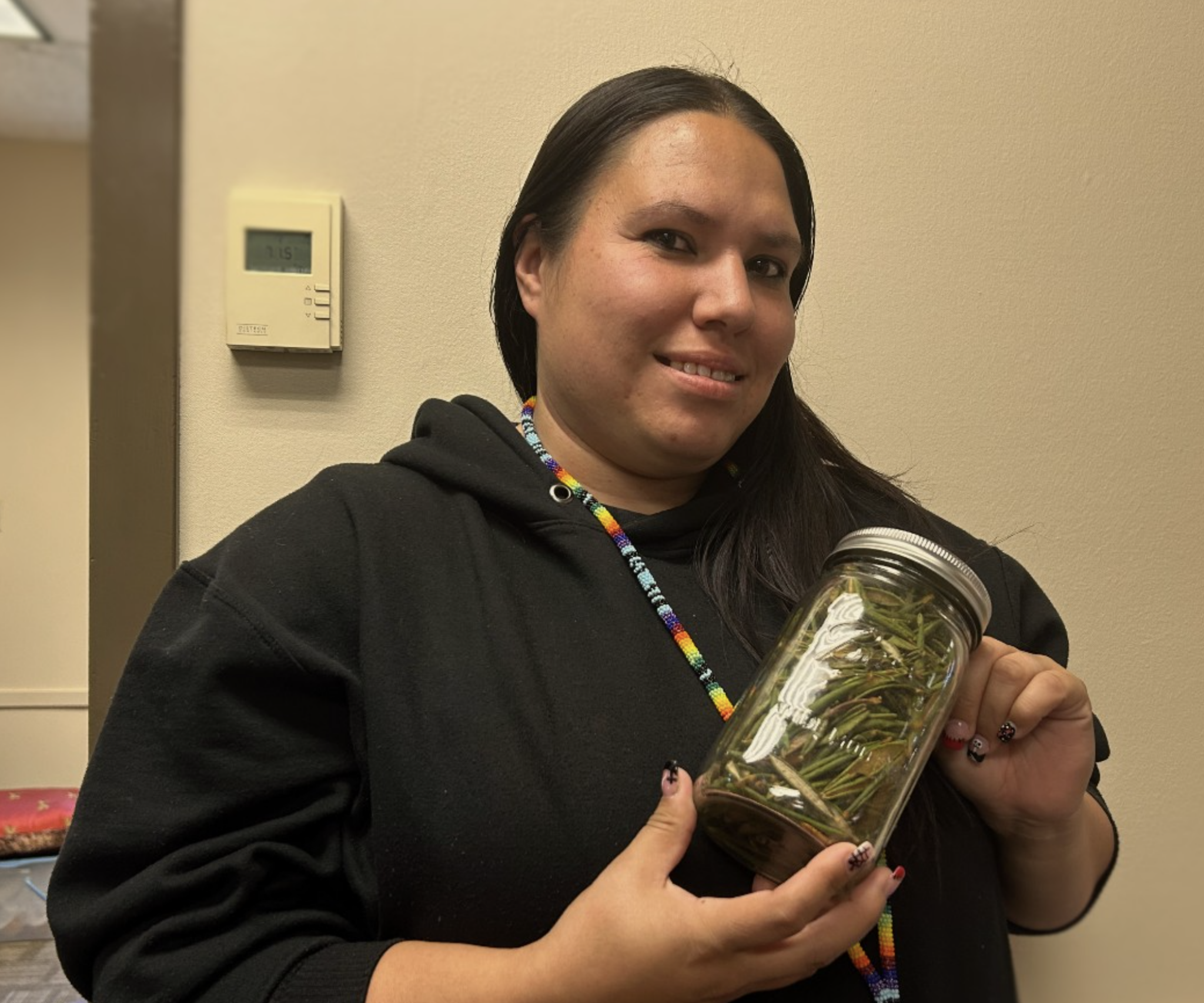 a person holding a jar of herbs