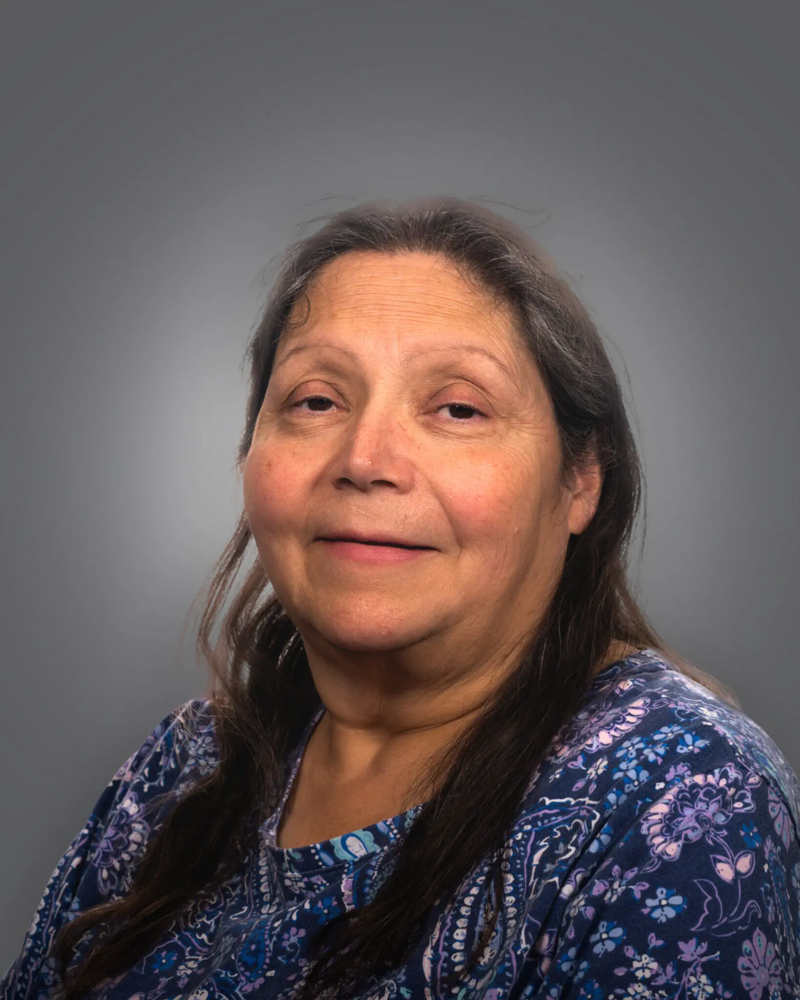 a person with long hair wearing a blue shirt
