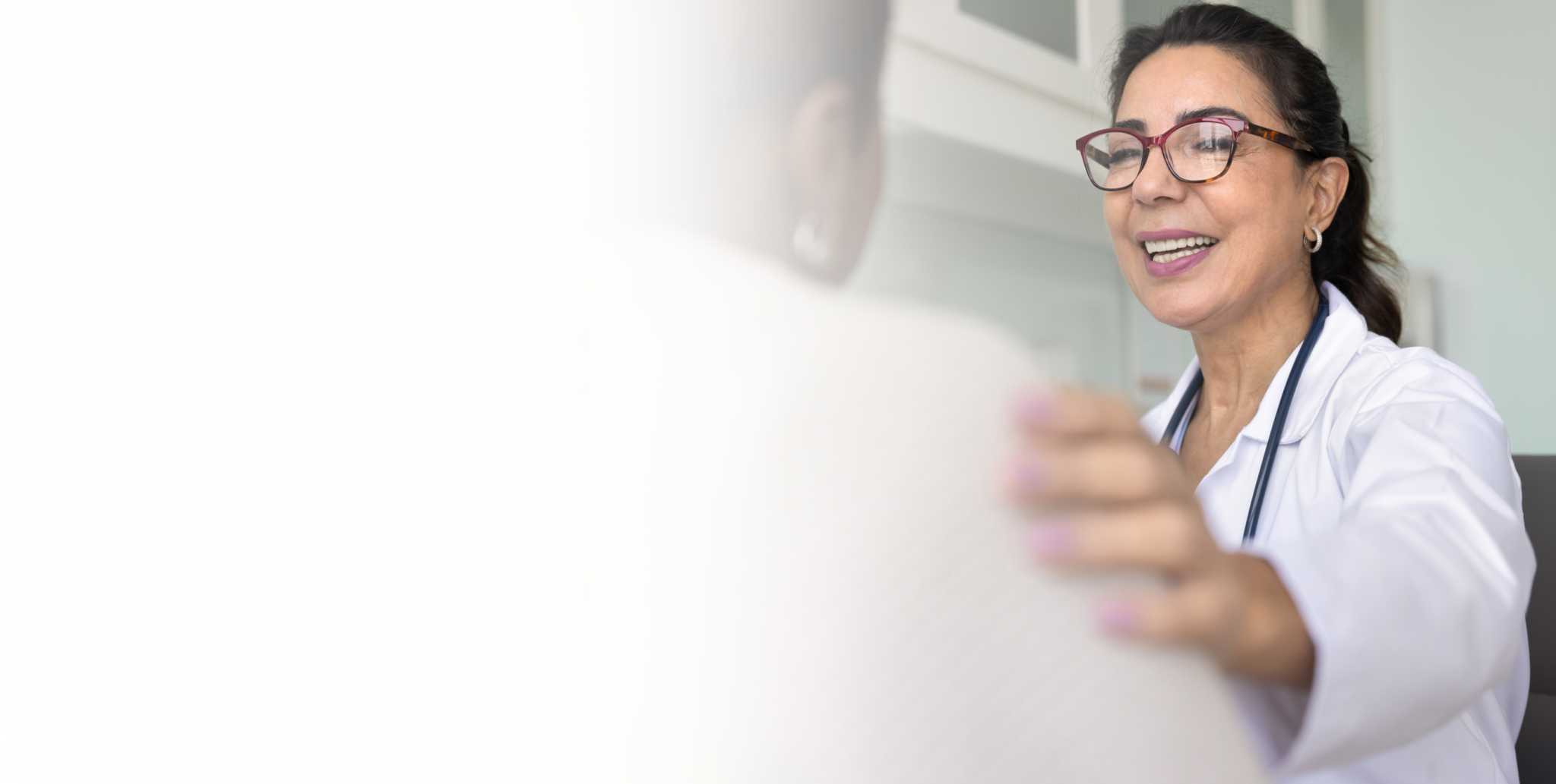 a person smiling and looking at a white board