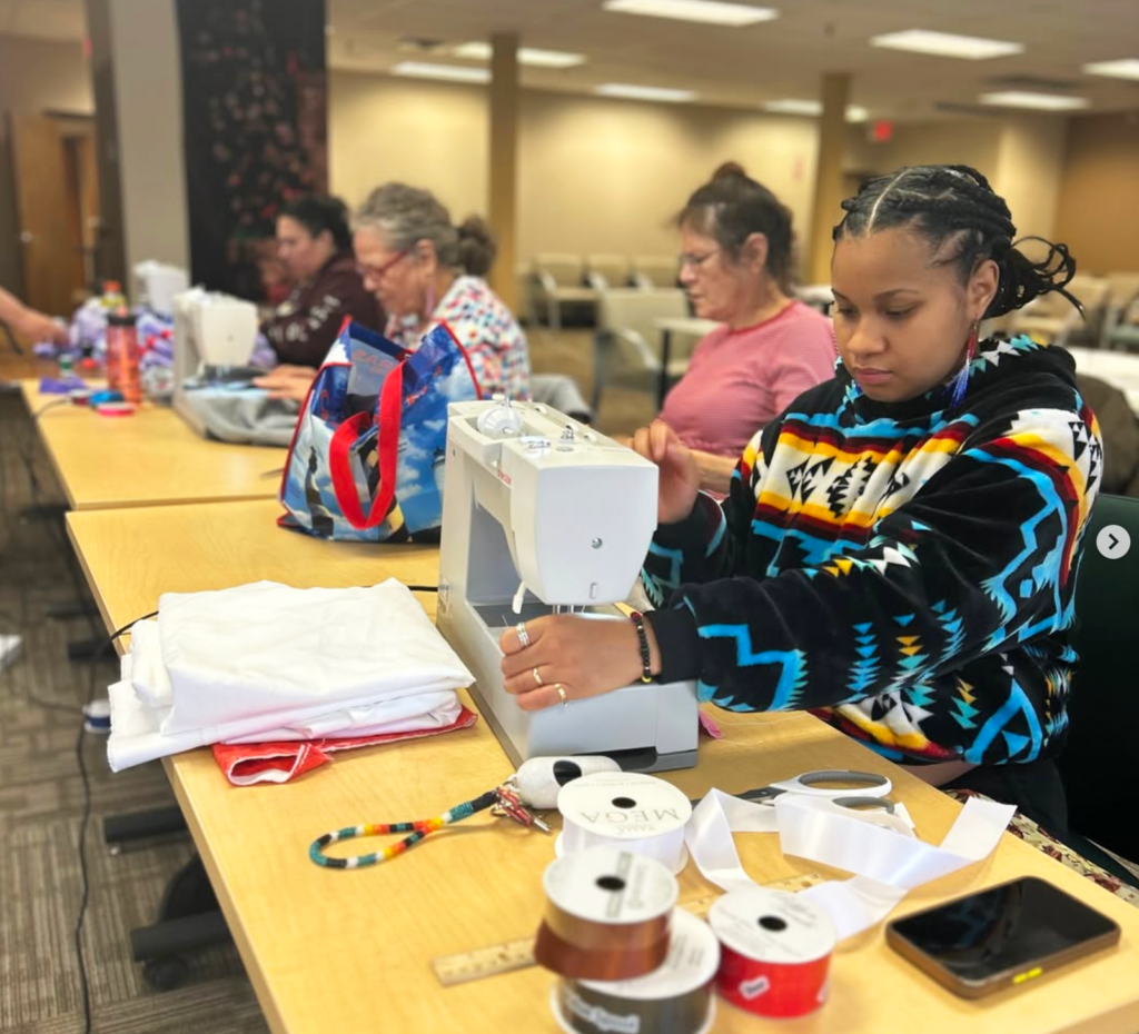 a person sewing on a sewing machine