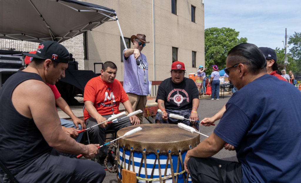 a group of men playing drums outside