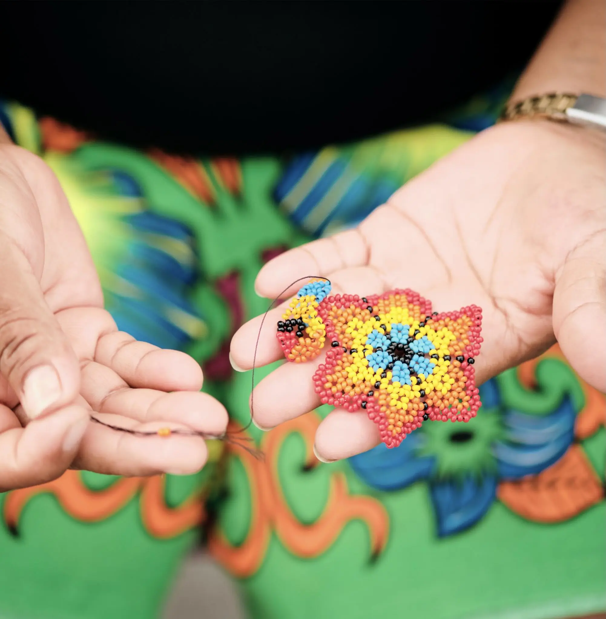 a person holding a beaded object
